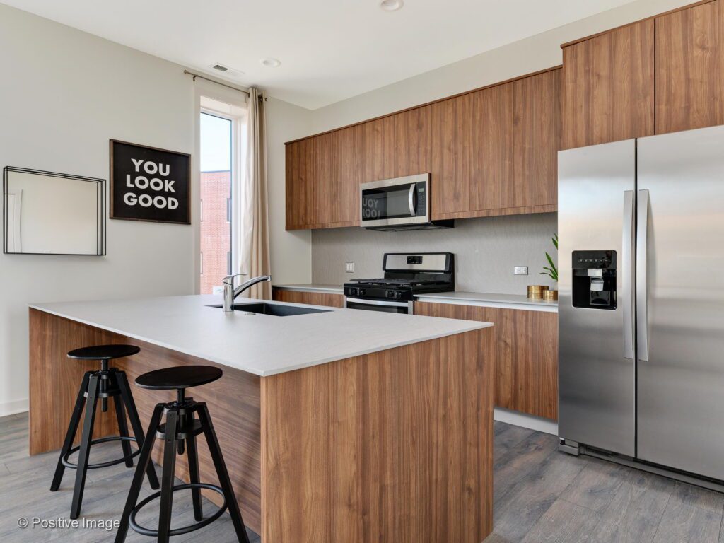 North-Oak-Lofts-Apartment-Homes-Modern-Kitchen-Island-with-Stainless-Steel-Appliances